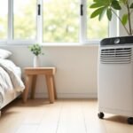 White portable air conditioner on castors in a modern Australian bedroom with its exhaust hose running to the window