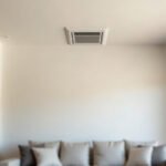 Ceiling-mounted ducted air conditioning vent in an Australian living room, part of a zoned ducted system.